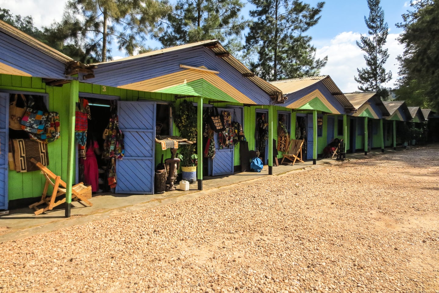 vendor posing in shop at Caplaki Craft Village in Kigali Rwanda